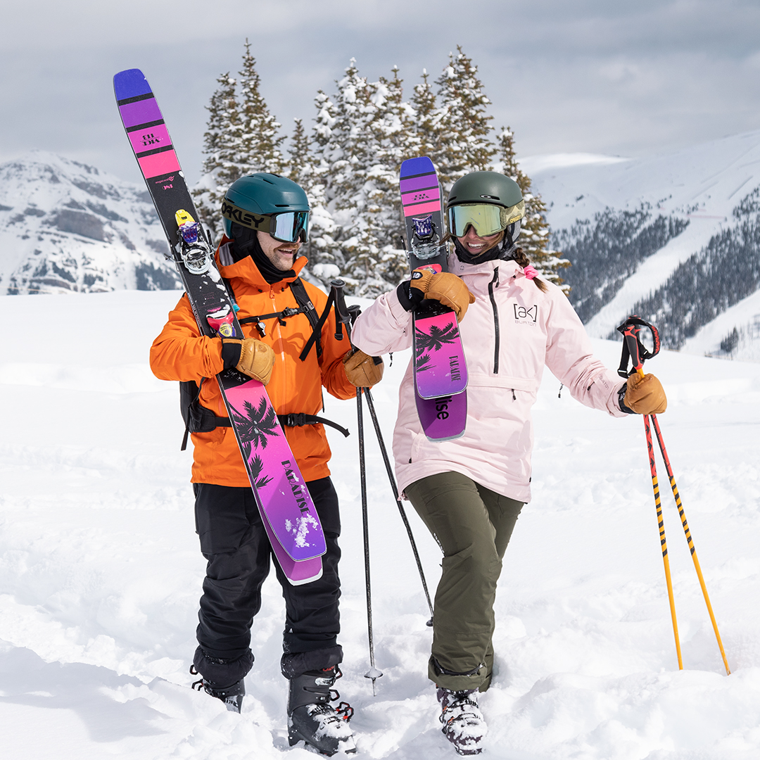 A couple walking with VICE 113 big-mountain skis at Banff Sunshine Village