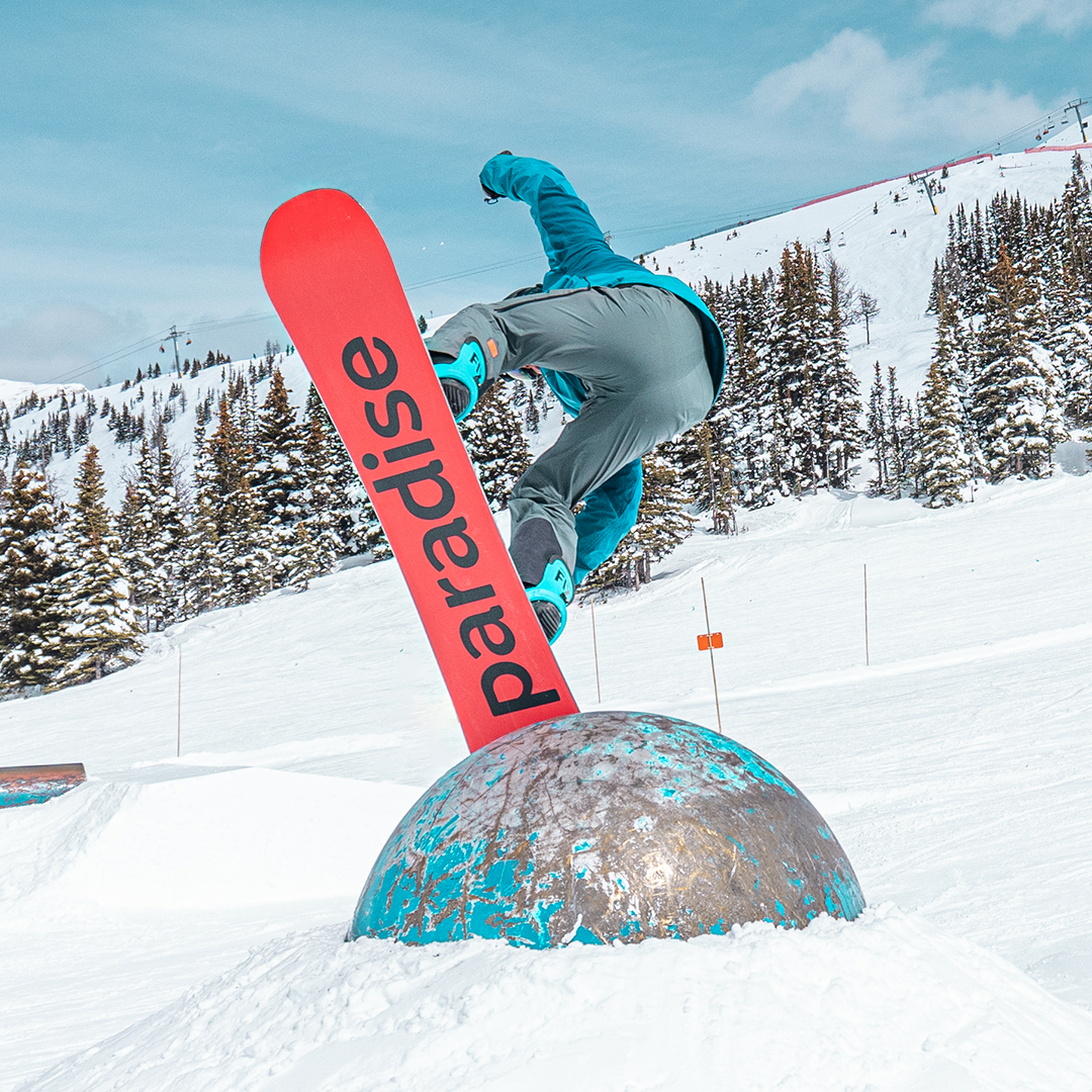 FLAMINGO all-mountain snowboard hitting a feature in a terrain park 