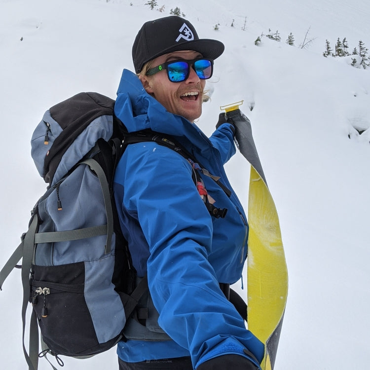 Cameron Brodrick - Co-Founder and Ski Engineer/Designer of Paradise Skis takes off a climbing skin from one of his touring skis.